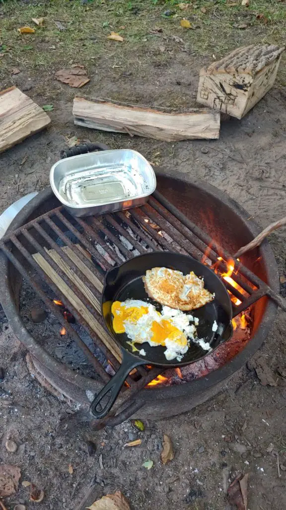 fried eggs in cast iron pan over fire