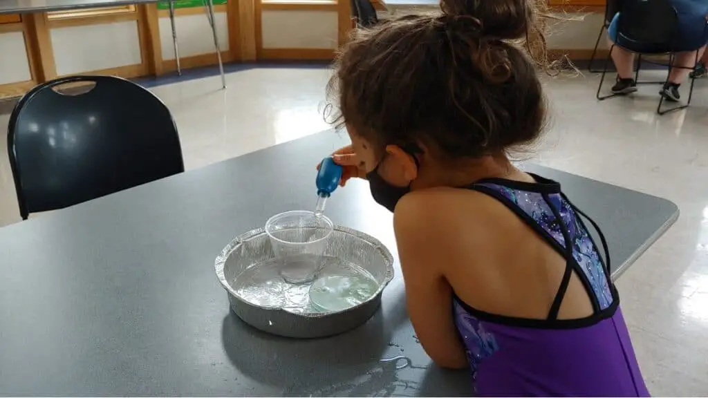 girl doing science experiment