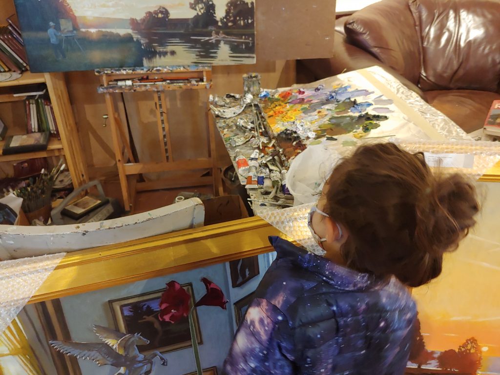 child looking at artist work