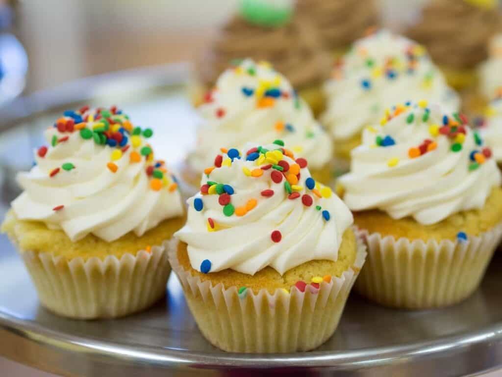 vanilla cupcakes with frosting and sprinkles