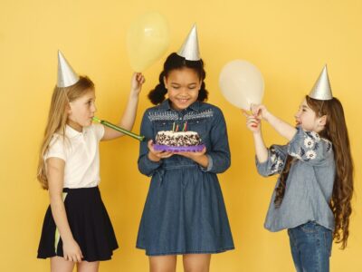 three children in birthday hats
