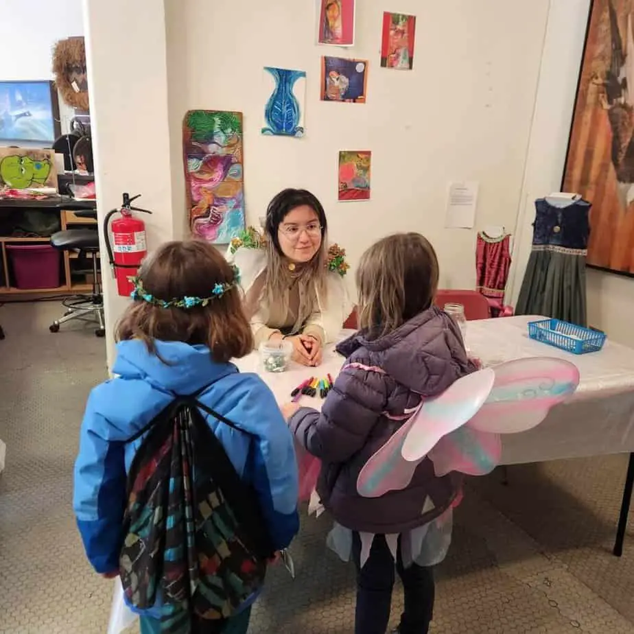 two girls making amulets at Fairy Fest